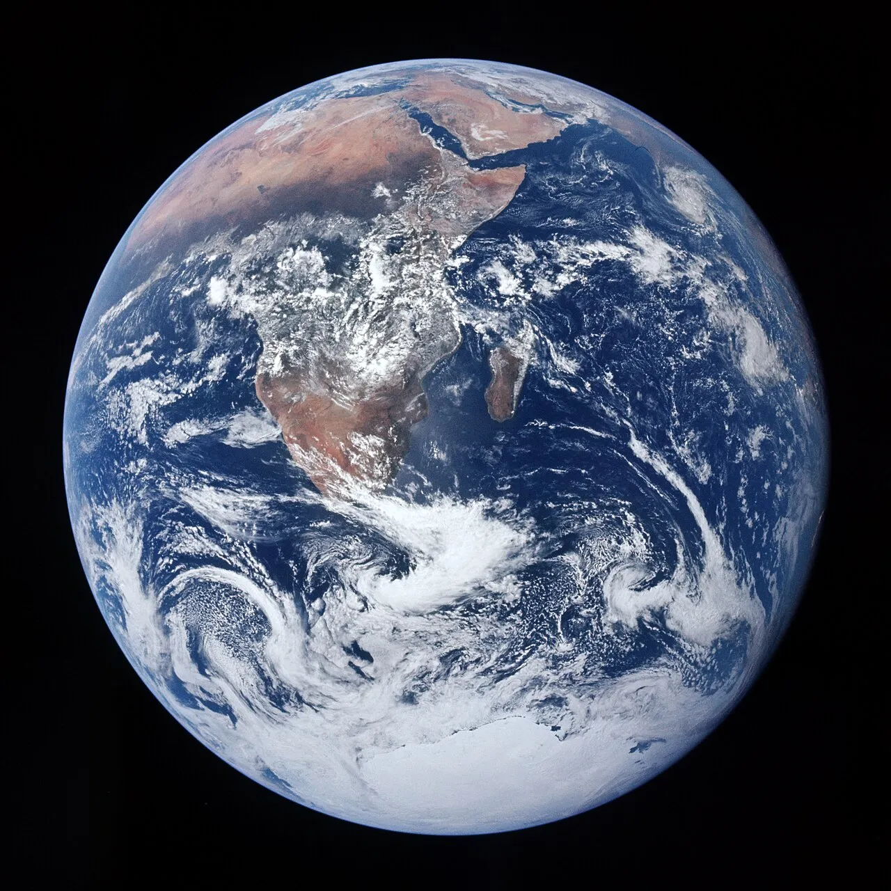 Die Erde als vollständig beleuchtete Kugel vor schwarzem Weltraum, mit Afrika, der Arabischen Halbinsel und der Antarktis — die Aufnahme „Blue Marble“ der Apollo-17-Besatzung.